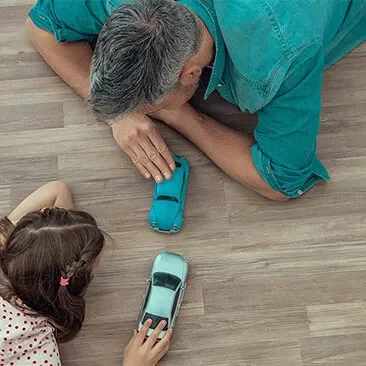 Dad girl playing with toy car | Haight Carpet & Interiors