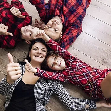 Happy family laying on floor | Haight Carpet & Interiors