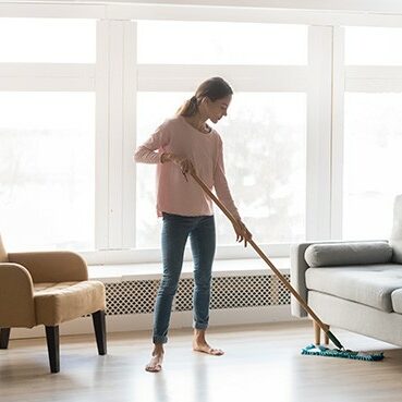 Women cleaning laminate floor | Haight Carpet & Interiors